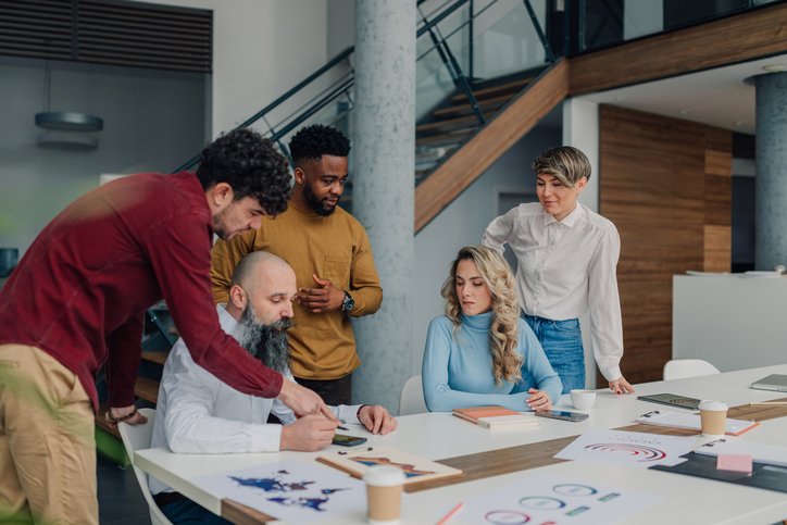 Marketing team analyzing world map puzzle during brainstorming session